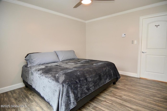 bedroom featuring a ceiling fan, crown molding, wood finished floors, and baseboards