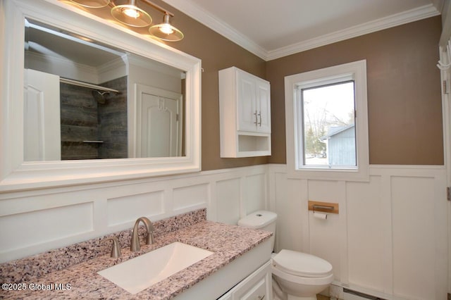 bathroom featuring vanity, tiled shower, a baseboard radiator, crown molding, and toilet