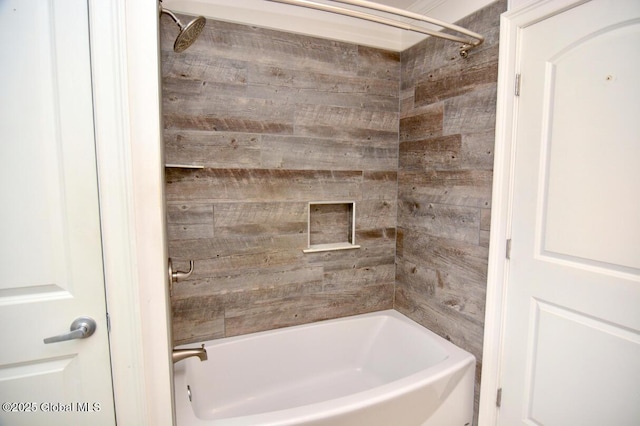 bathroom with wood walls and shower / bathtub combination