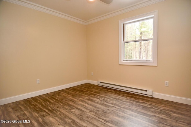 spare room featuring baseboard heating, wood finished floors, baseboards, and ornamental molding