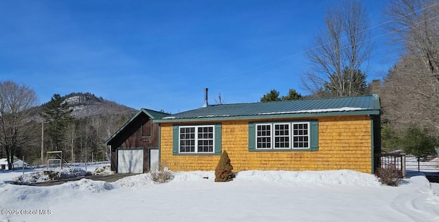 view of front facade featuring metal roof and a garage