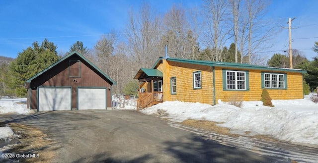 view of front of house featuring a detached garage and an outdoor structure