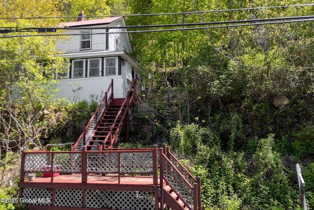 83 N Williams St, Whitehall, NY 12887 - back of property with stairway, a wooden deck, and a wooded view