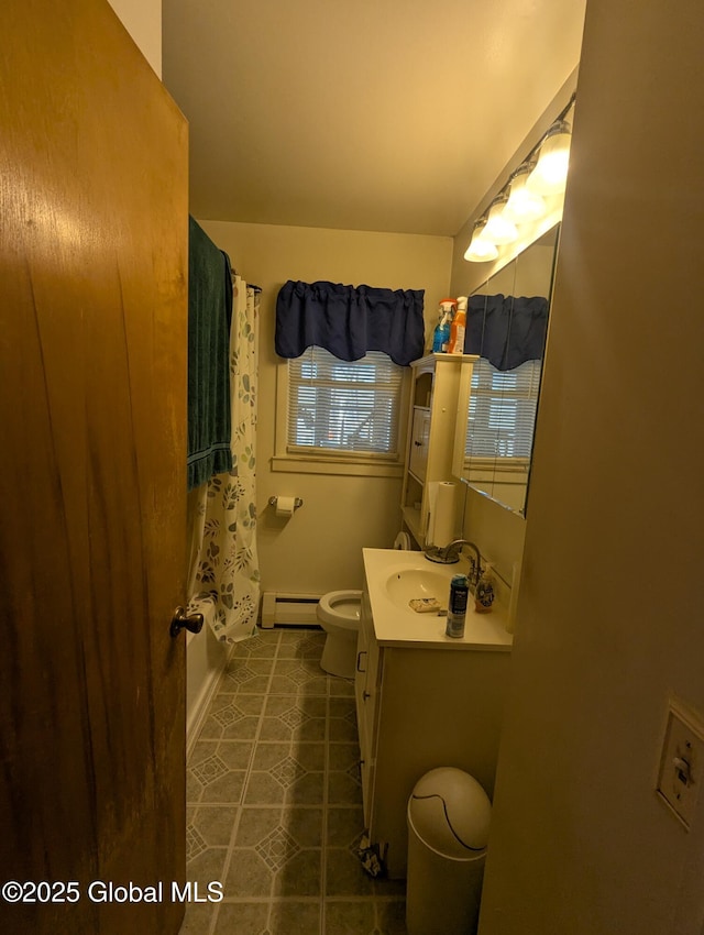 full bathroom featuring tile patterned flooring, baseboard heating, toilet, and vanity