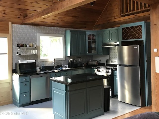 kitchen with under cabinet range hood, dark countertops, appliances with stainless steel finishes, and wooden ceiling