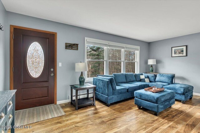 1263 Best Rd, East Greenbush, NY 12061 - living room featuring baseboards, light wood-type flooring, and baseboard heating