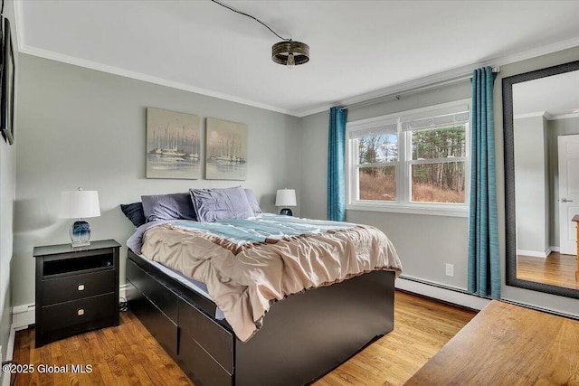 1263 Best Rd, East Greenbush, NY 12061 - bedroom featuring wood finished floors, crown molding, baseboards, a baseboard radiator, and baseboard heating