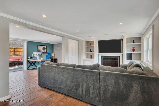 1263 Best Rd, East Greenbush, NY 12061 - living room with recessed lighting, wood finished floors, ornamental molding, and a glass covered fireplace