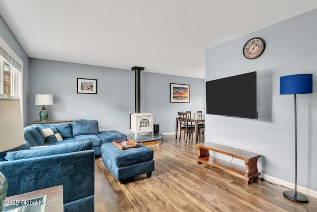 1263 Best Rd, East Greenbush, NY 12061 - living room with baseboards, wood finished floors, and a wood stove
