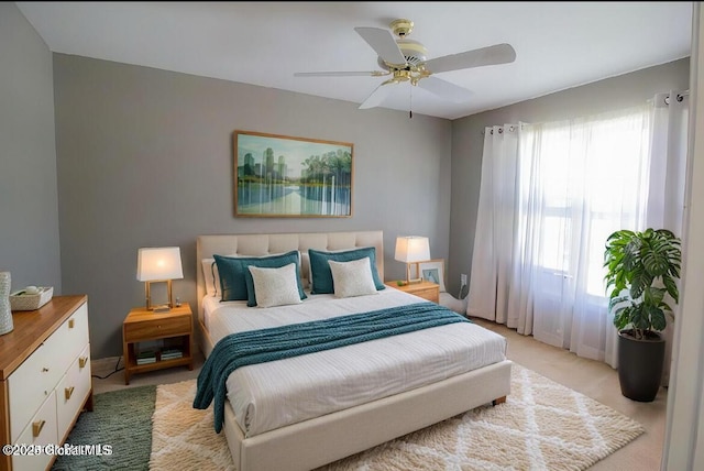 bedroom with light carpet and a ceiling fan