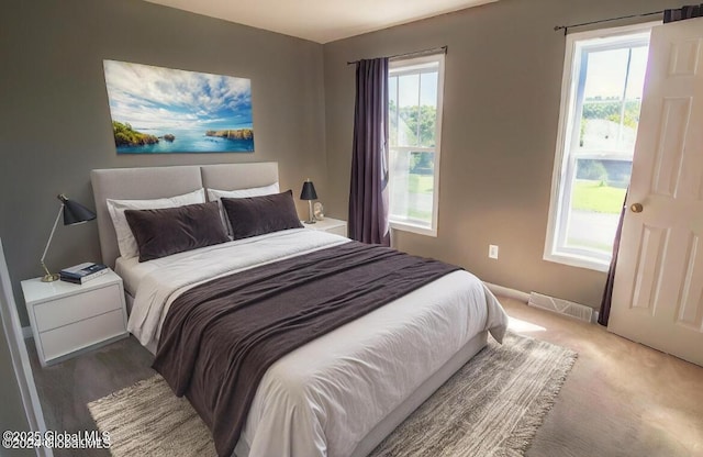 bedroom featuring visible vents and carpet flooring