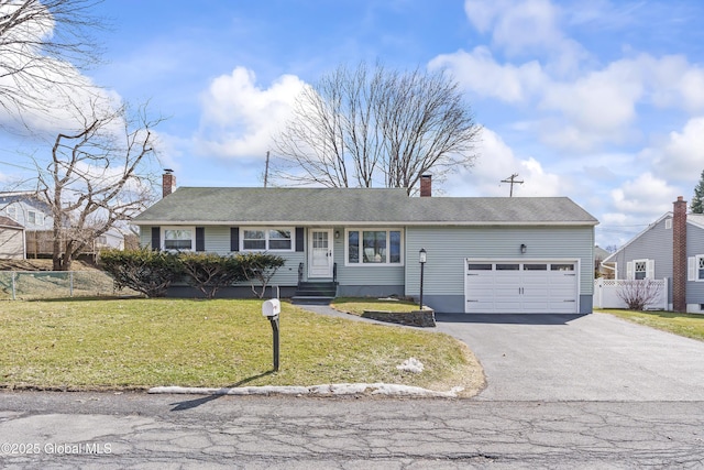 view of front of home featuring a front yard, fence, driveway, and a chimney