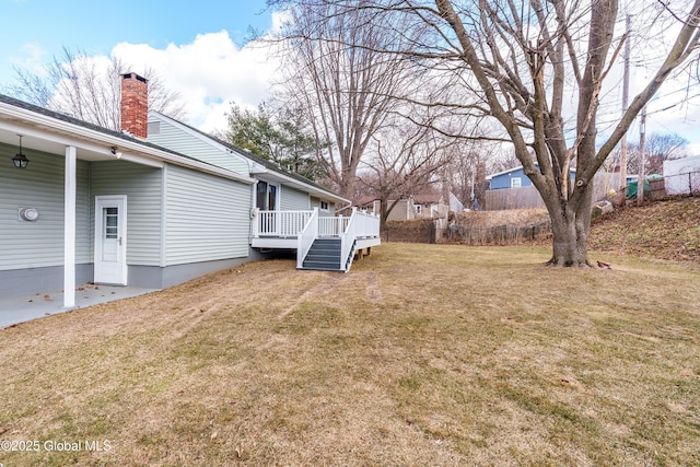 view of yard with a deck and fence