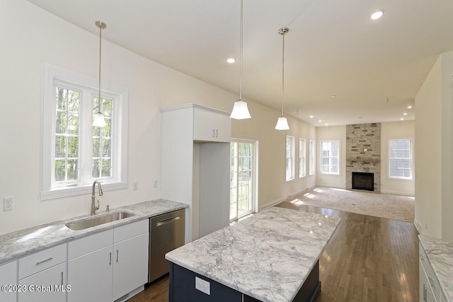 kitchen featuring dark wood-type flooring, dishwasher, recessed lighting, white cabinets, and a sink