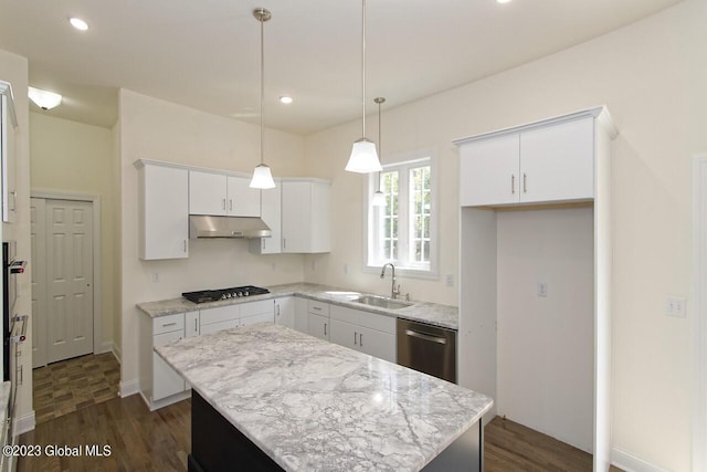 kitchen with under cabinet range hood, a sink, a kitchen island, stainless steel dishwasher, and gas stovetop