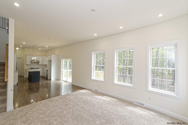 unfurnished living room with visible vents, recessed lighting, stairs, and baseboards