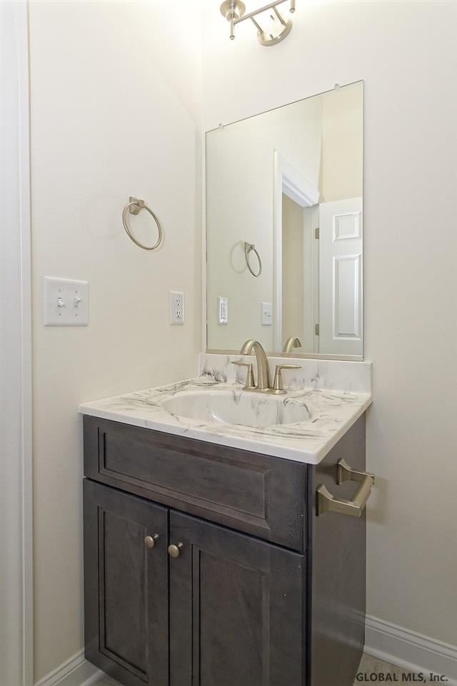 bathroom featuring vanity and baseboards