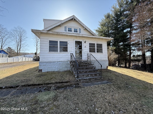 bungalow-style home with fence