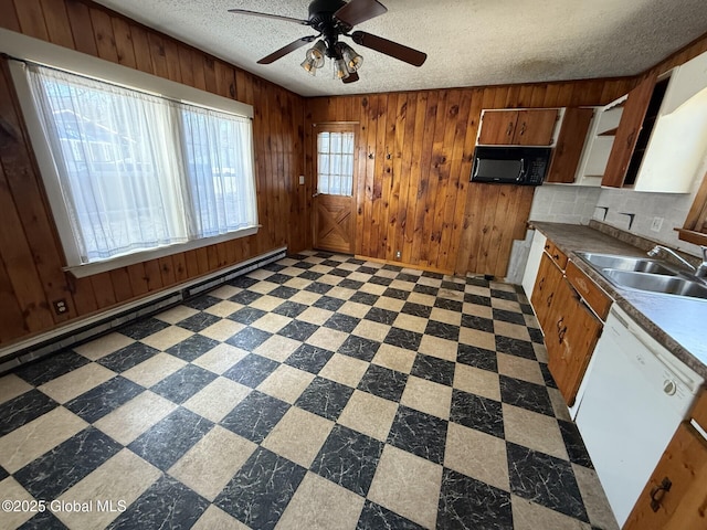 kitchen with a sink, dishwasher, black microwave, and tile patterned floors