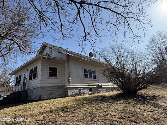 view of property exterior featuring a chimney