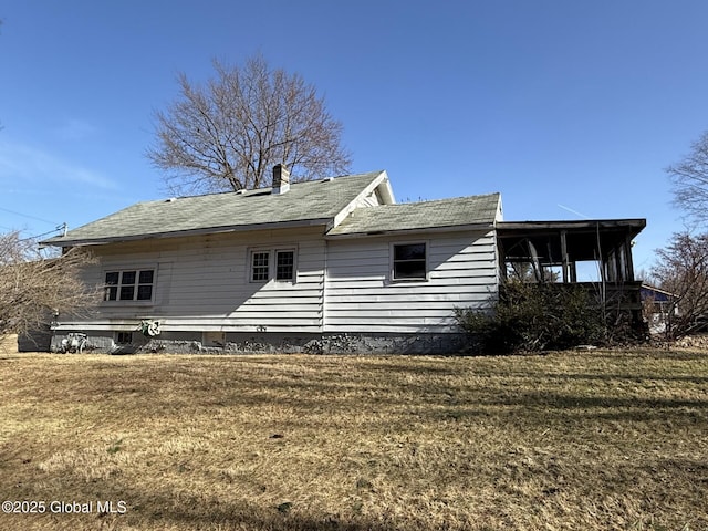 rear view of house with a yard