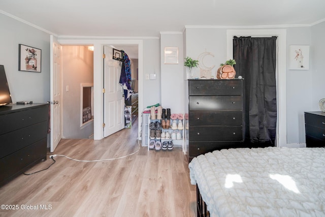 bedroom featuring crown molding and wood finished floors