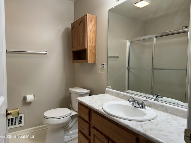 bathroom featuring a shower with shower door, visible vents, toilet, and vanity