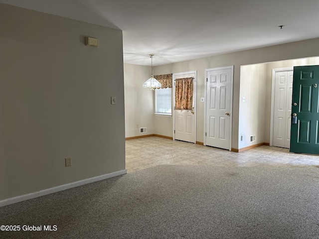 unfurnished room featuring visible vents, baseboards, a chandelier, and light carpet