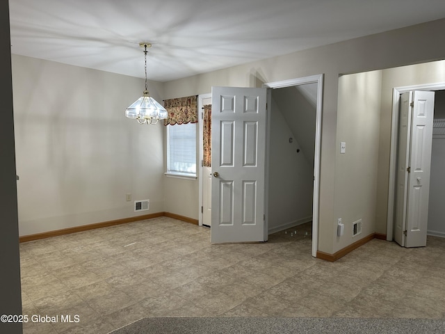 interior space with visible vents, baseboards, and an inviting chandelier