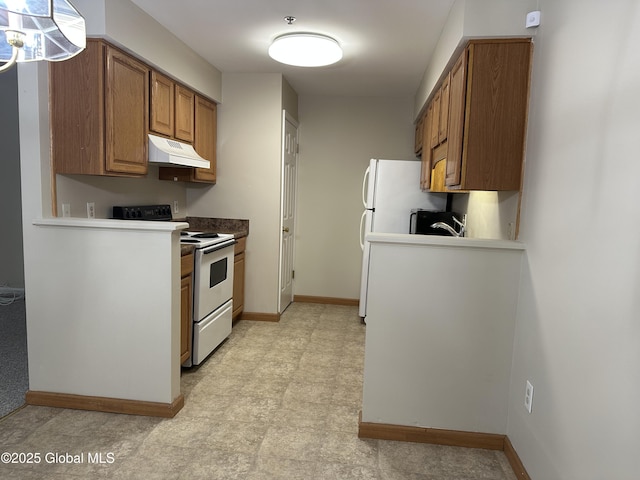 kitchen with baseboards, under cabinet range hood, light floors, brown cabinets, and white appliances