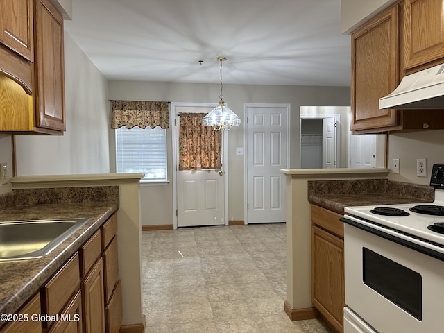 kitchen with white electric range oven, under cabinet range hood, dark countertops, a notable chandelier, and brown cabinets