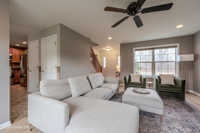 living area with light tile patterned flooring, stairway, baseboards, ceiling fan, and recessed lighting