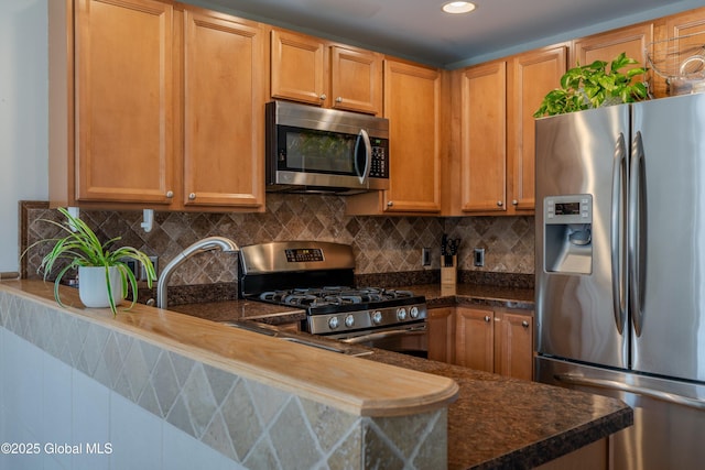 kitchen with a sink, recessed lighting, backsplash, and appliances with stainless steel finishes
