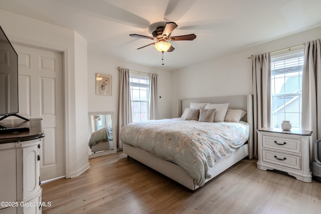 bedroom featuring light wood-style flooring and a ceiling fan