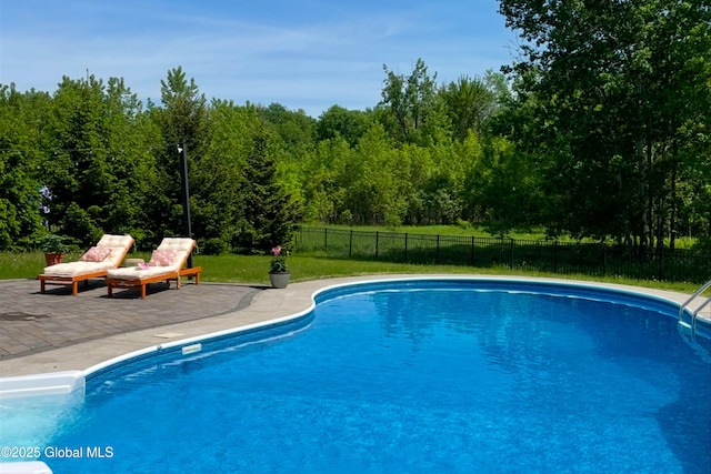 view of swimming pool featuring fence, a fenced in pool, and a patio area