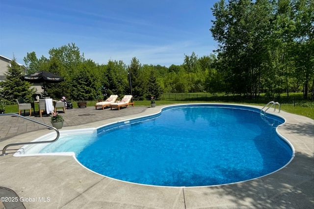 view of swimming pool with a fenced in pool, fence, and a patio area