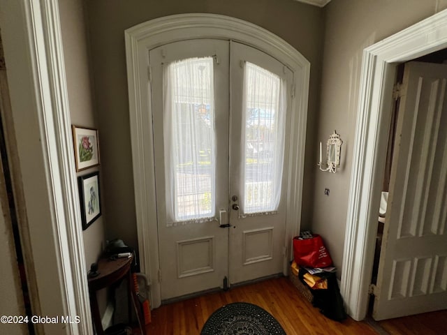 foyer featuring wood finished floors and french doors