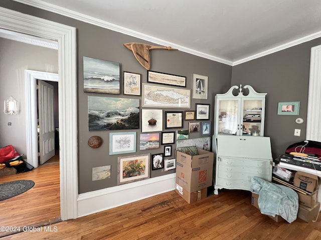 interior space featuring wood finished floors and ornamental molding