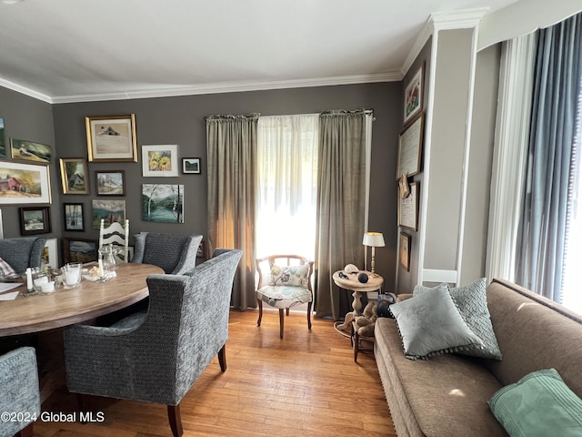 dining area featuring crown molding and light wood finished floors