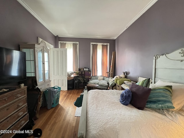 bedroom featuring crown molding and wood finished floors