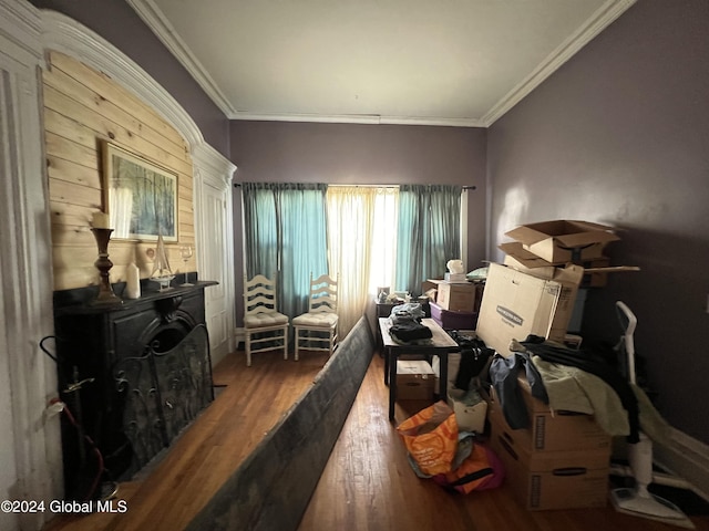 interior space featuring wood finished floors and ornamental molding