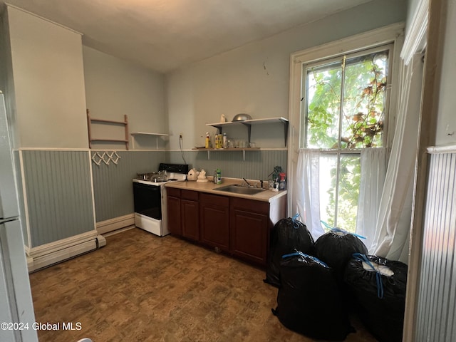 kitchen with a wainscoted wall, white electric stove, open shelves, a sink, and light countertops