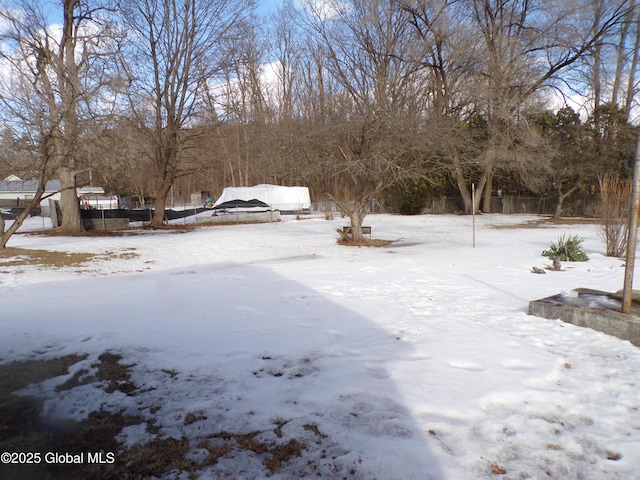 yard layered in snow with fence