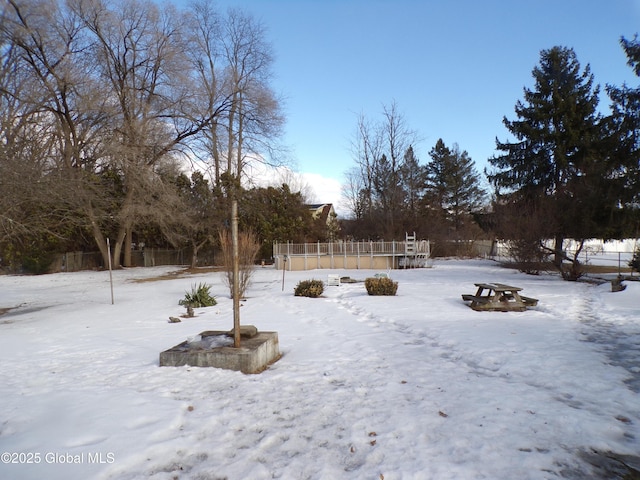 yard layered in snow with fence