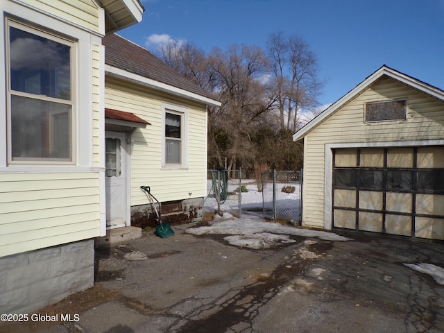 garage with fence and driveway