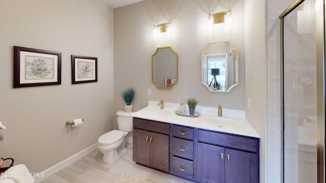 bathroom with double vanity, an enclosed shower, toilet, and a sink