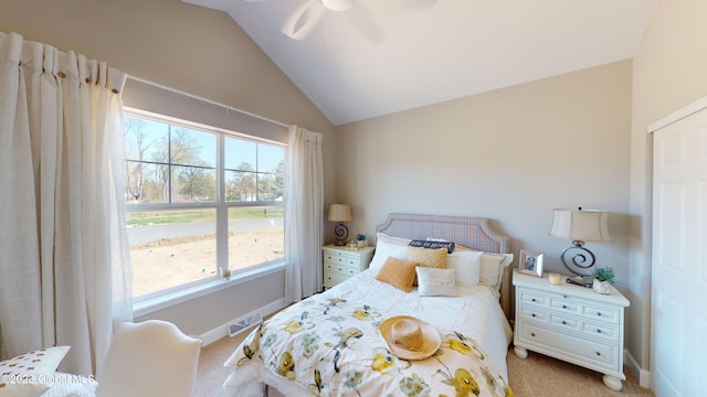 bedroom featuring visible vents, baseboards, ceiling fan, light colored carpet, and lofted ceiling