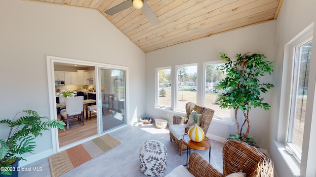 sunroom featuring vaulted ceiling, a ceiling fan, and wooden ceiling