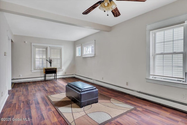 unfurnished room featuring beamed ceiling, a ceiling fan, and wood finished floors