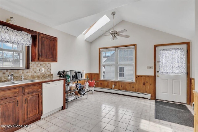 kitchen featuring a wainscoted wall, a ceiling fan, a sink, a baseboard radiator, and dishwasher